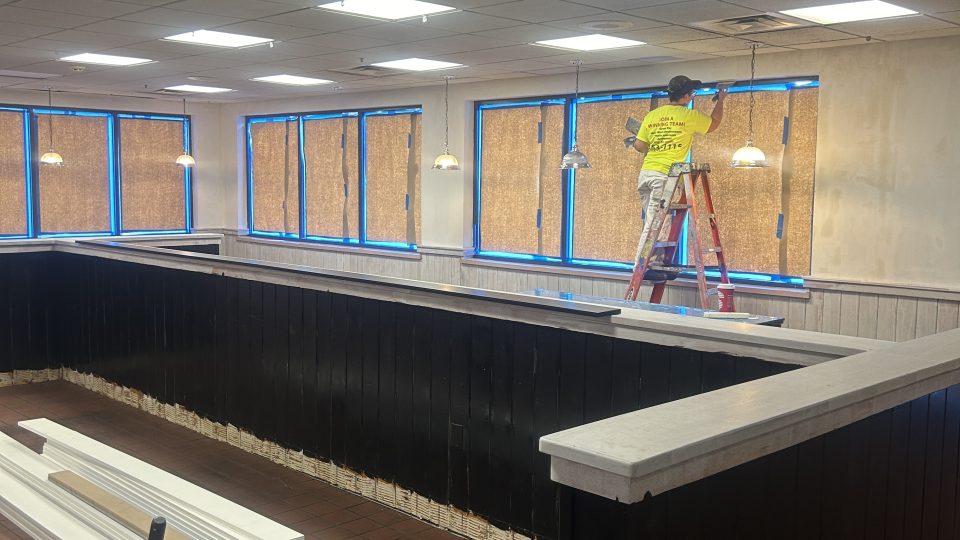 paint-of-wny-office-commercial-painting - Paint of WNY professional-painter-paints-trim-in-office-building